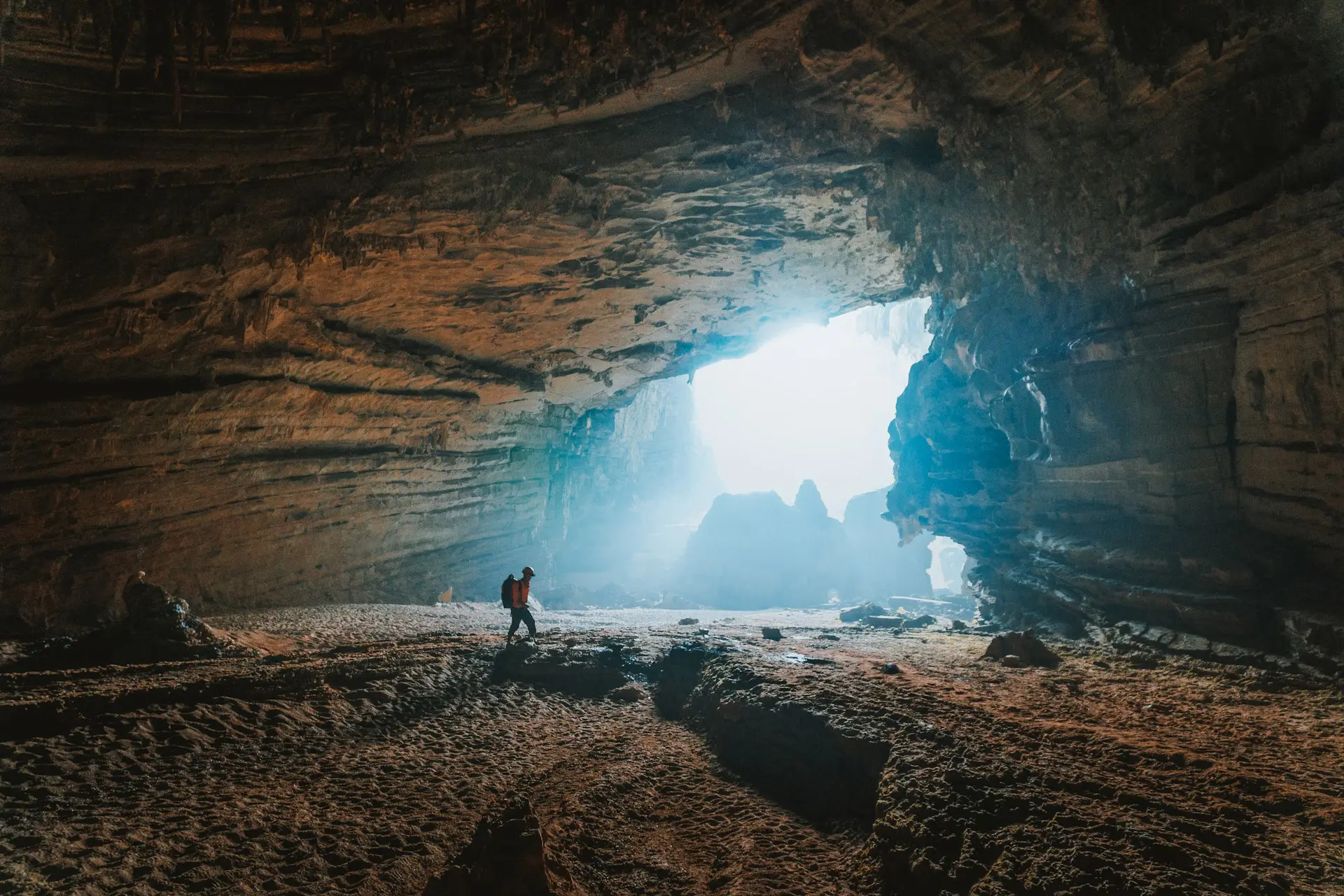 person exploring a cave