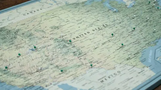 Map of the United States with green and white pins throughout the states