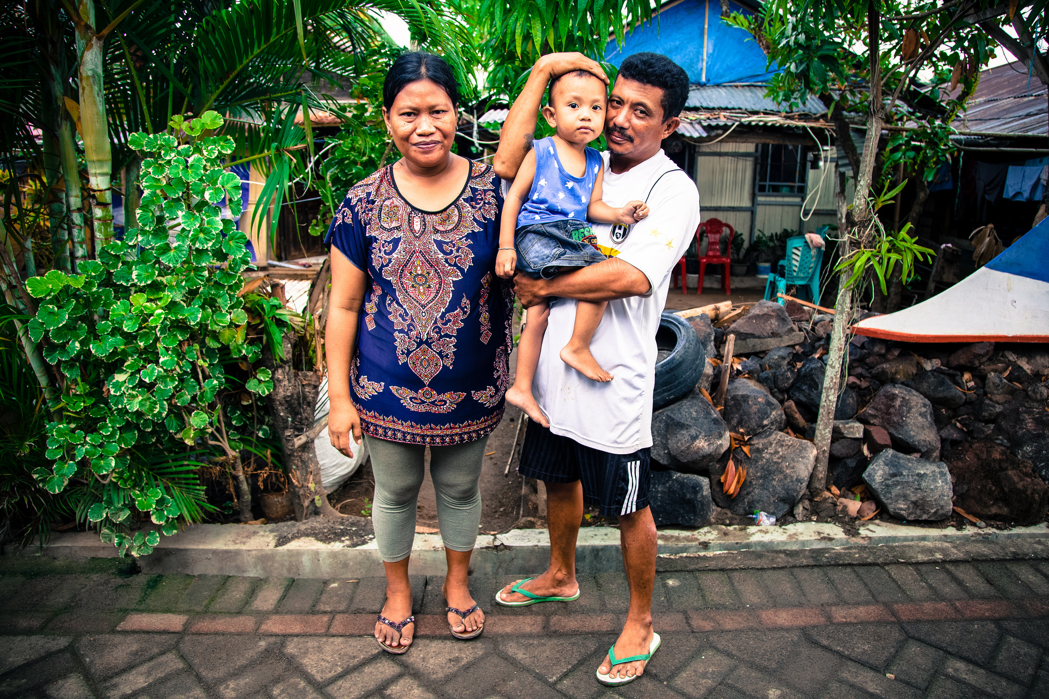 beneficiary - family of three in front of a house