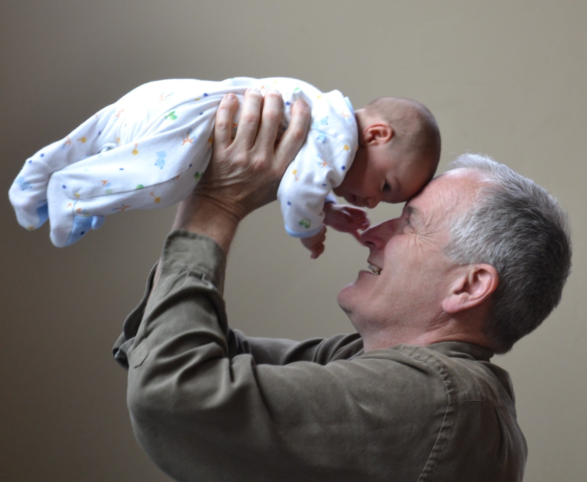 Living Trusts or Wills - person holding up baby