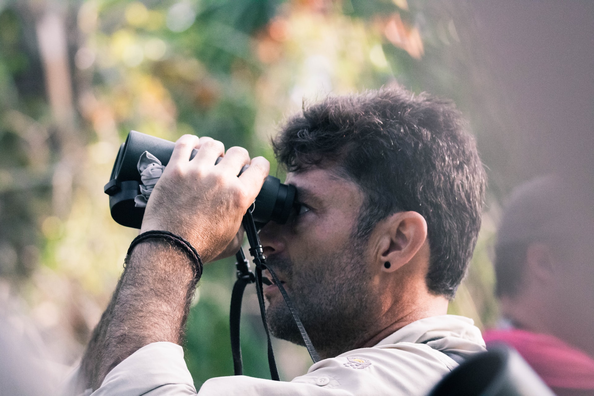 birding in phoenix - close up of man bird watching with binoculars