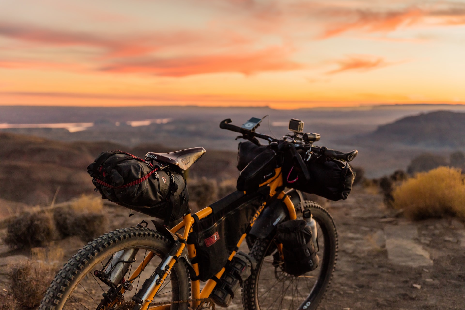 best bike trails in phoenix -- bike parked on a mountain top with sunset in the distance