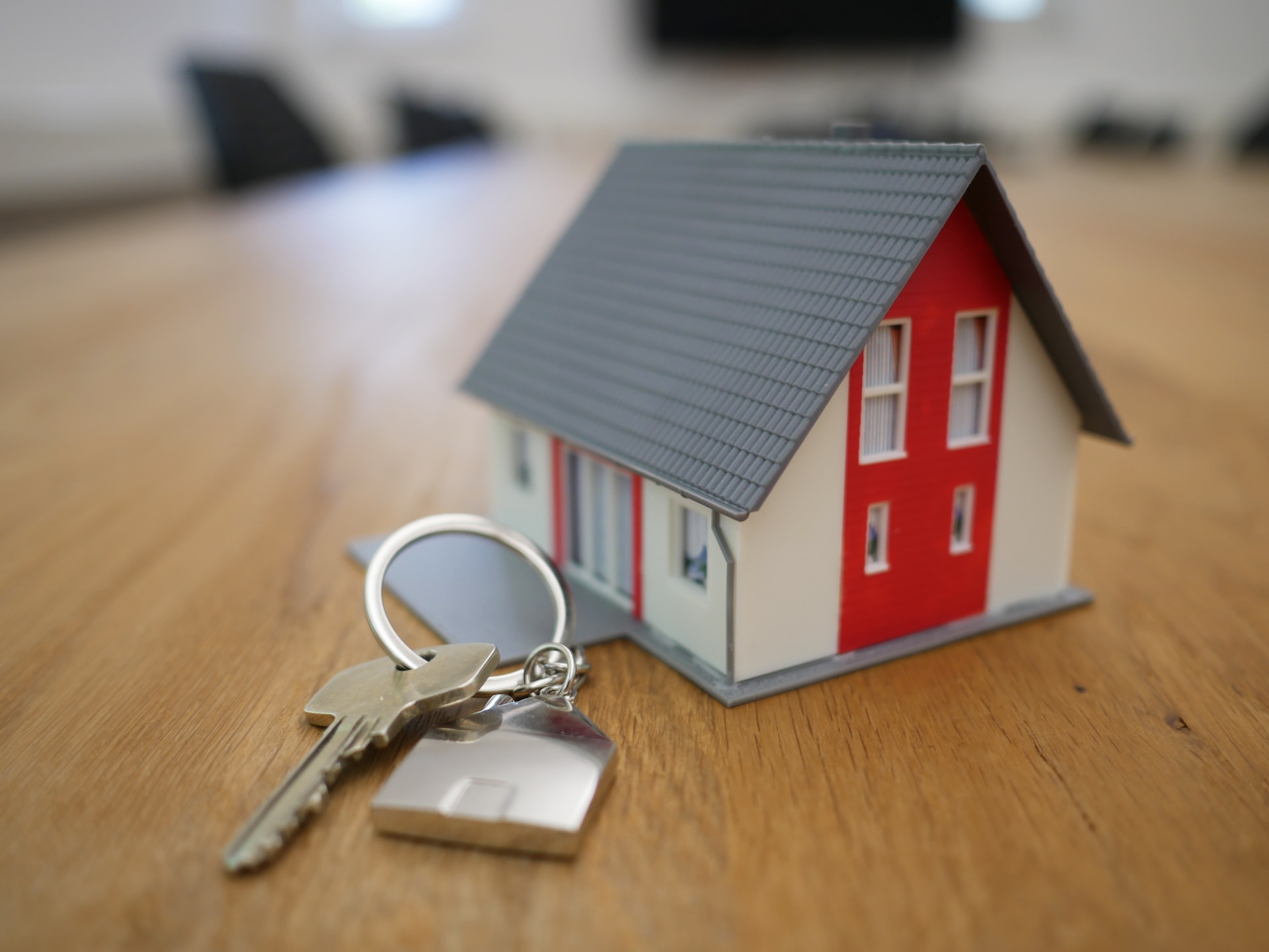 keys and tiny model house on desk