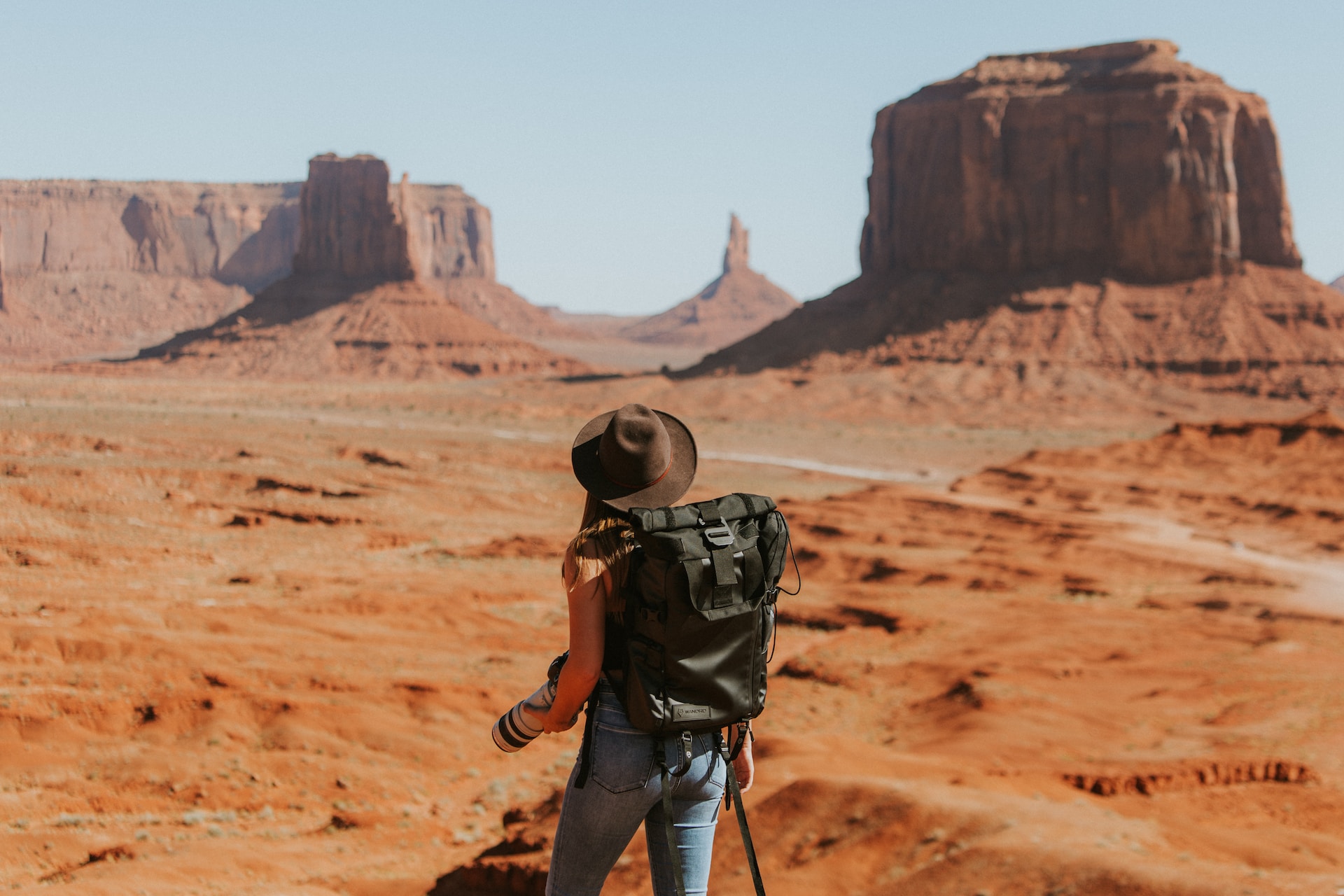 woman wearing backpack hiking in arizona desert